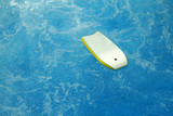 surf board floating on blue sea water