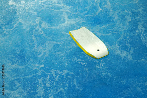 surf board floating on blue sea water