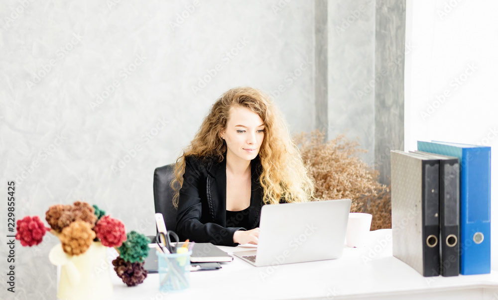 © pic for you - happy young woman working on laptop in workplace.entrepreneur working at start up.Business woman in office start-up working on laptop.