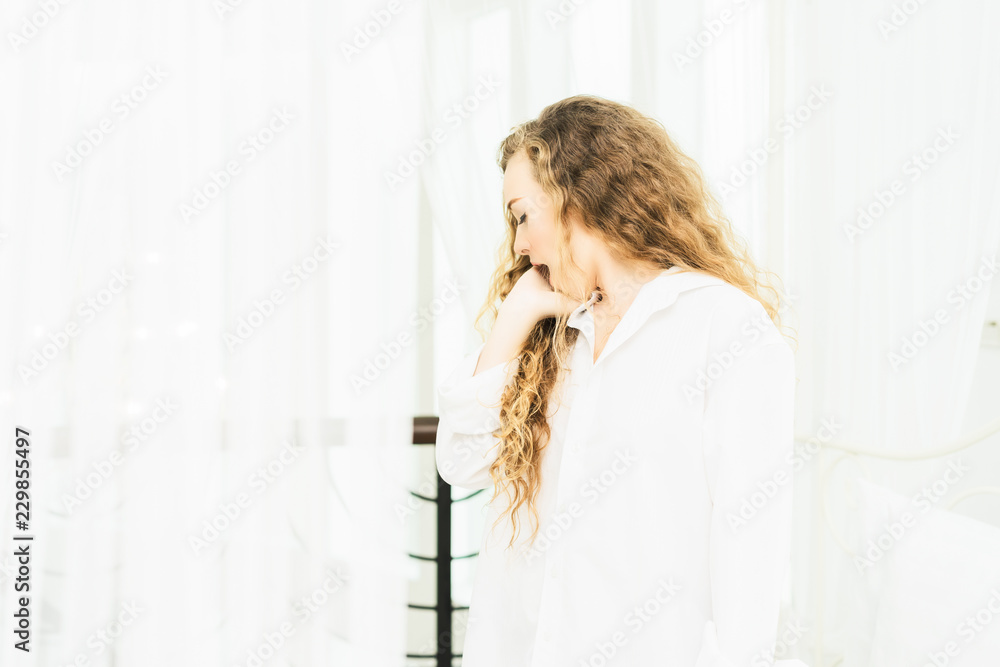 Young woman was stretching, relaxing after waking up in the morning on the bed in her bedroom.good morning,holiday