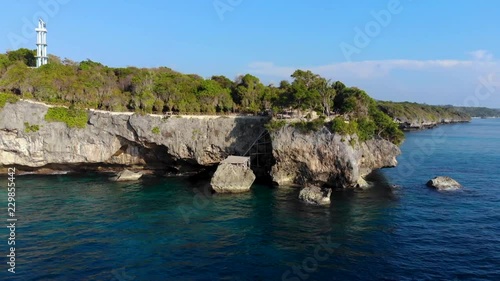 Aerial Backwards video of Steep Cliff Shoreline with beautiful sea, coral forest & sky landscape photo