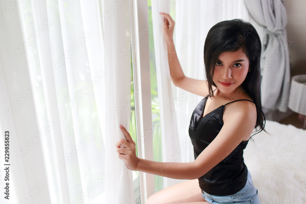 young woman wake up and see view from bedroom window young woman wake up and see view from bedroom window