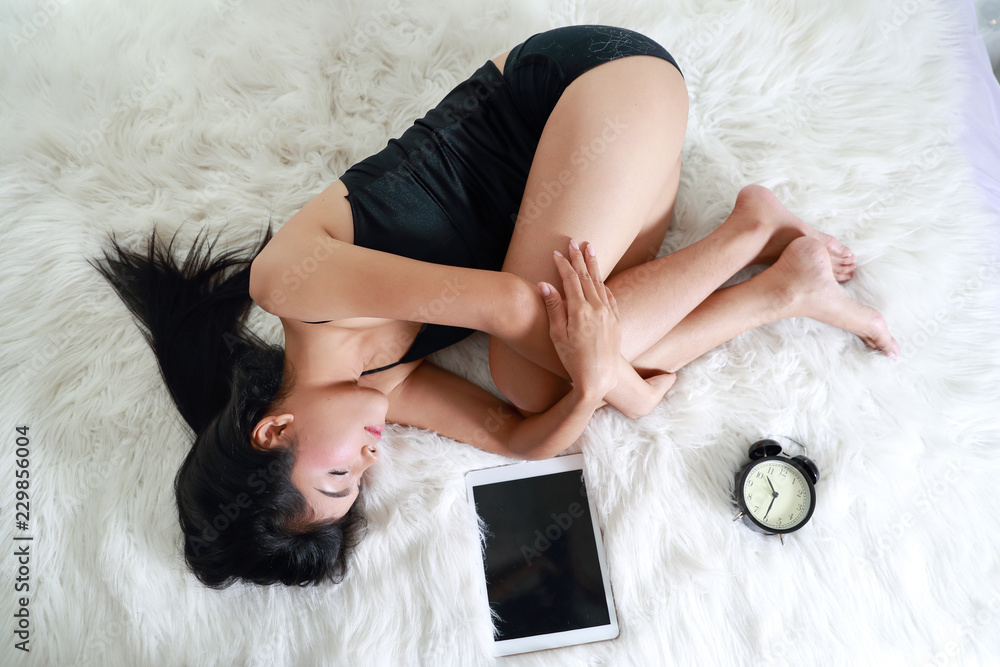 beautiful woman fall asleep with tablet and alarm clock beautiful woman fall asleep with tablet and alarm clock