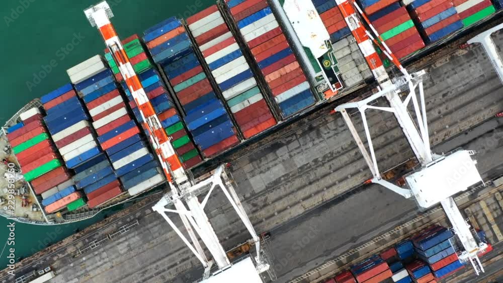 Aerial top view crane shipping container, cargo container ship carrying ...