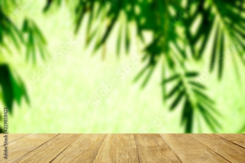 Empty top wooden table on soft blur Bamboo tree with garss in sun light natural background