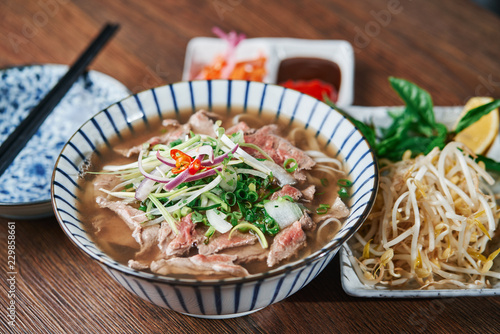 Vietnamese Phở Beef Noodle Soup Bowl with vegetable