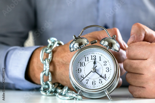 Business concept with businessman trapped or chained to time.