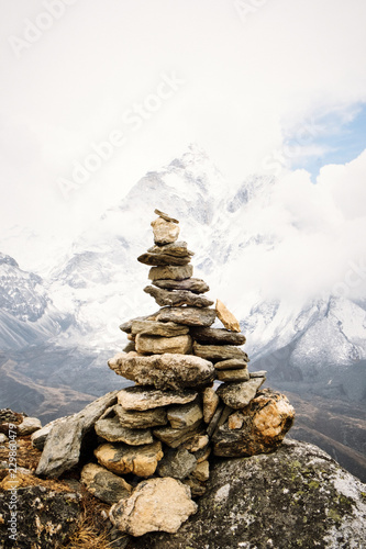 View of cairn marks against snowcapped mountain