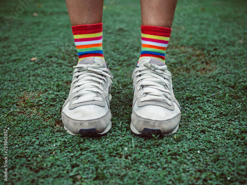 Colorful stylish socks on green field
