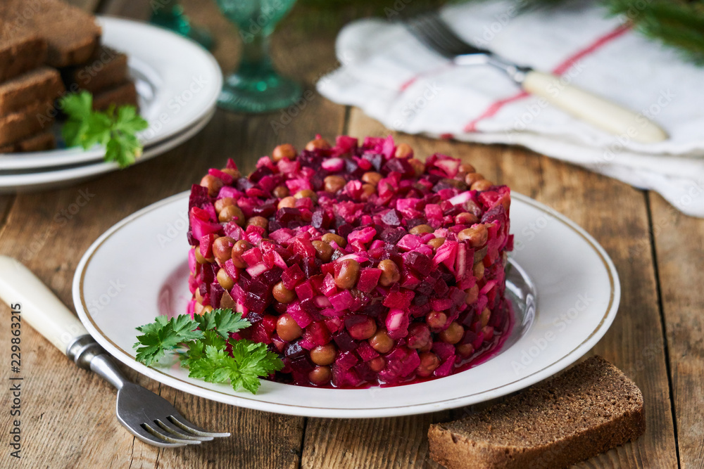 Vegetable salad vinaigrette with beetroot, potatoes, pickles and green peas on a plate Vegetable salad vinaigrette with beetroot, potatoes, pickles and green peas on a plate