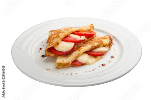 Breakfast. Pancakes with mozzarella and tomatoes. On a white background