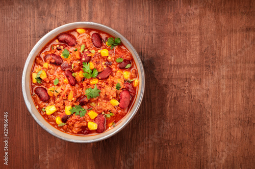 Chili con carne, traditional Mexican dish, overhead photo with a place for text