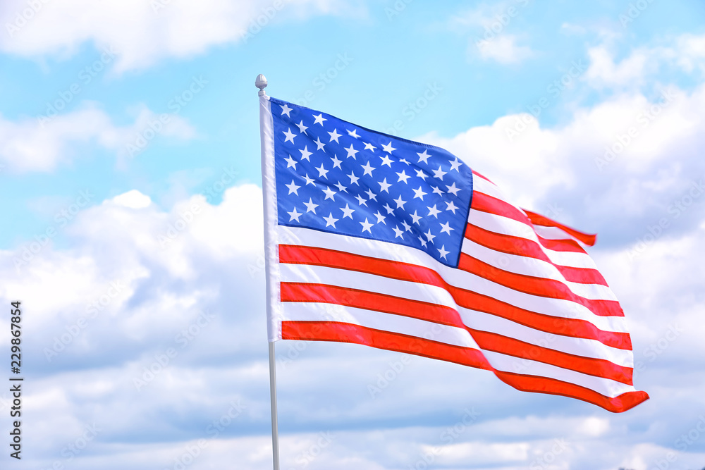 Naklejka premium American flag outdoors on cloudy day. Space for text