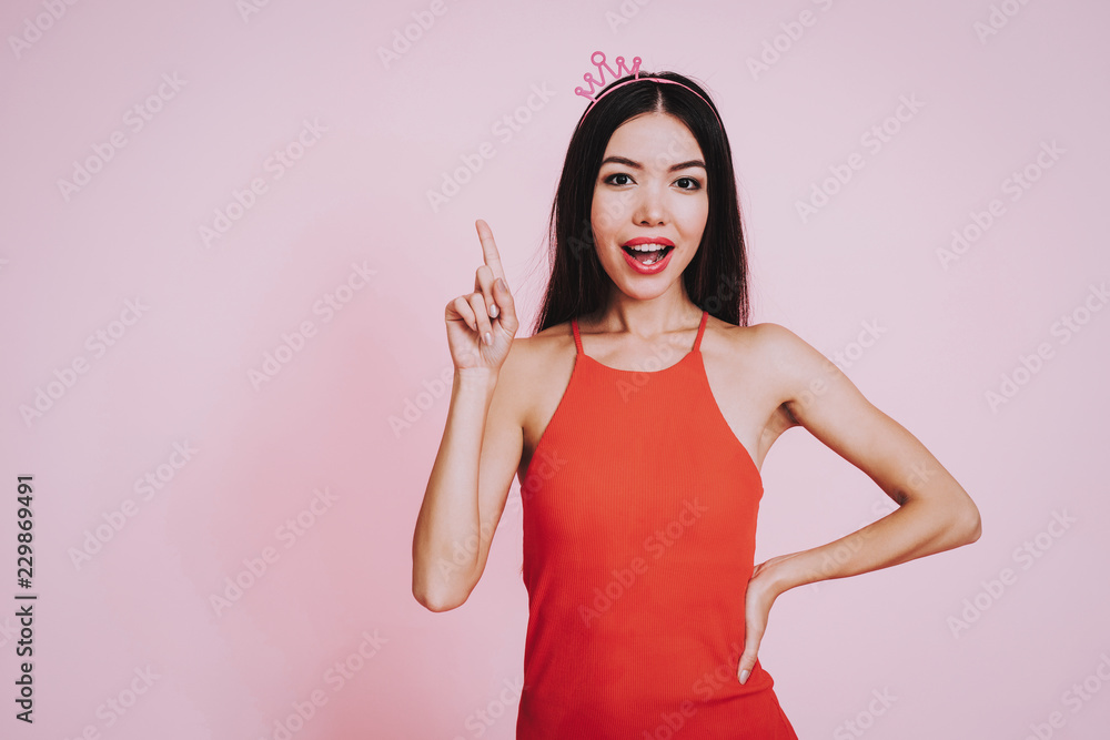 Girl with Raised Finger Up on Pink Background. Girl with Raised Finger Up on Pink Background.