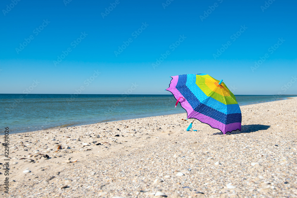 Colorful umbrella lies the beach