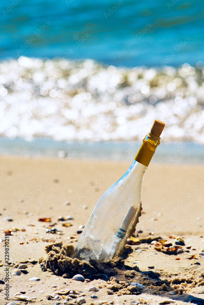 Bottle with a message, lying on the seashore