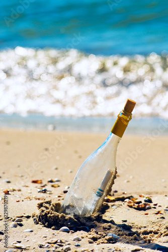 Bottle with a message, lying on the seashore