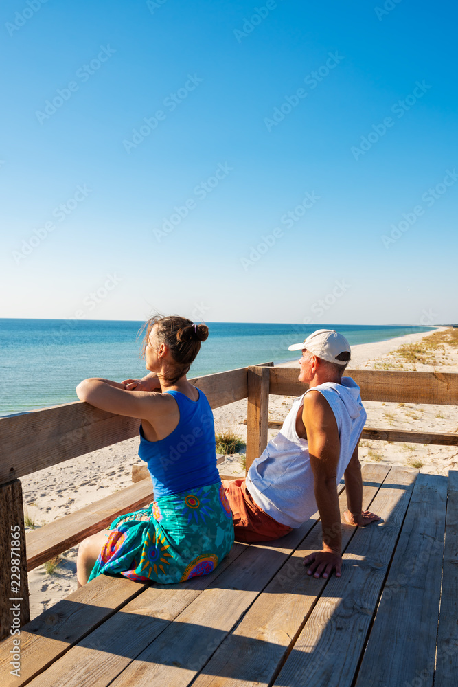 Couple of travelers relaxes on a bungalow veranda