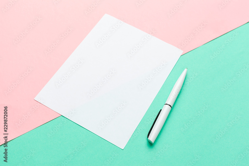 White paper notepad on pastel color background.Flat lay design. White paper notepad on pastel color background.Flat lay design.