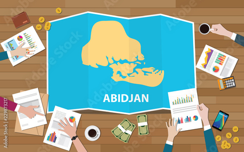 abidjan cote de ivoire city region economy growth with team discuss on fold maps view from top