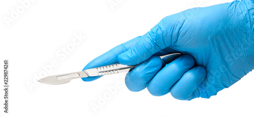 фотографія Scalpel in the hands of doctor in gloves isolated on white background