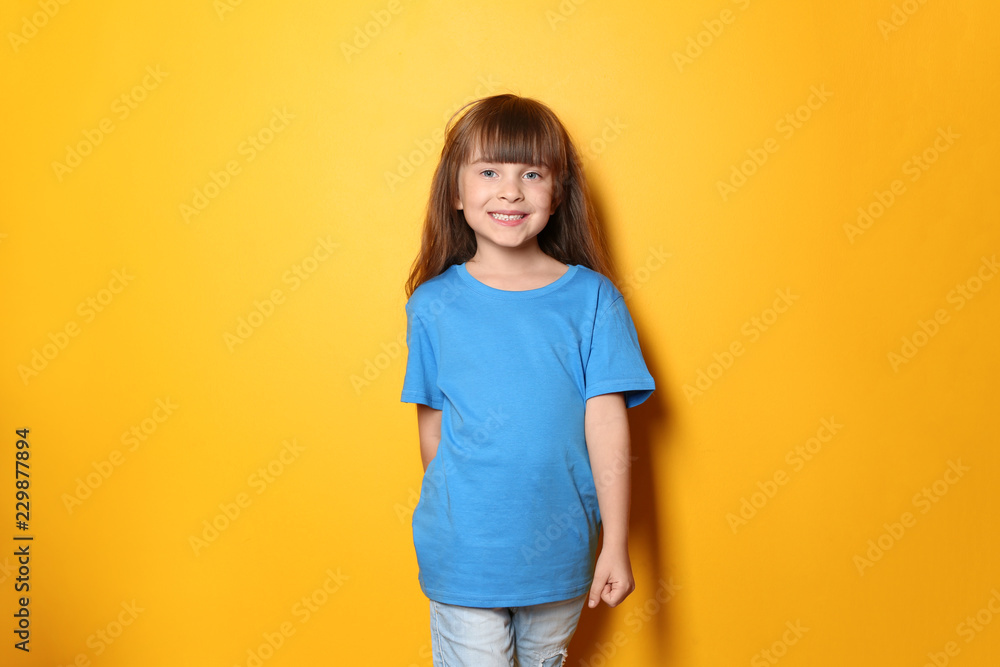 Little girl in t-shirt on color background Little girl in t-shirt on color background