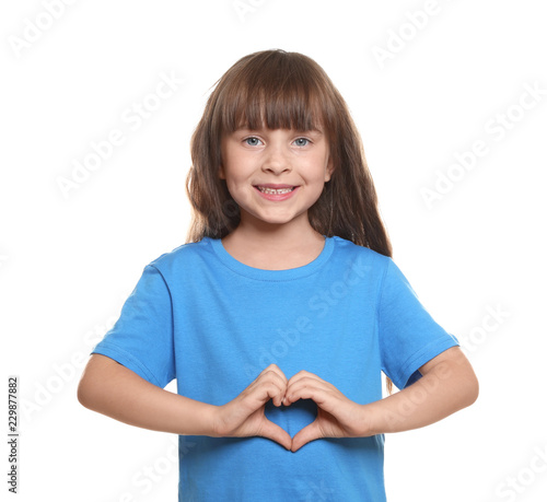 Little girl in t-shirt maki...