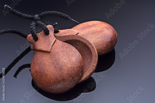 A pair of Spanish castanets on a glass table