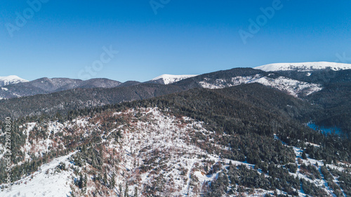 Aerial view of the mountains. Bukovel. Carpathians. Snow. Winter. Forest. Trees. Day.