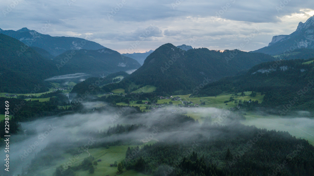 Aerial view of the morning foggy landscape in the alpine mountains Aerial view of the morning foggy landscape in the alpine mountains