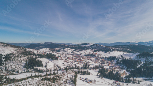 Aerial view of the mountains. Carpathians. Bukovel. Village. Winter. Snow. Forest. Trees © viacheslav