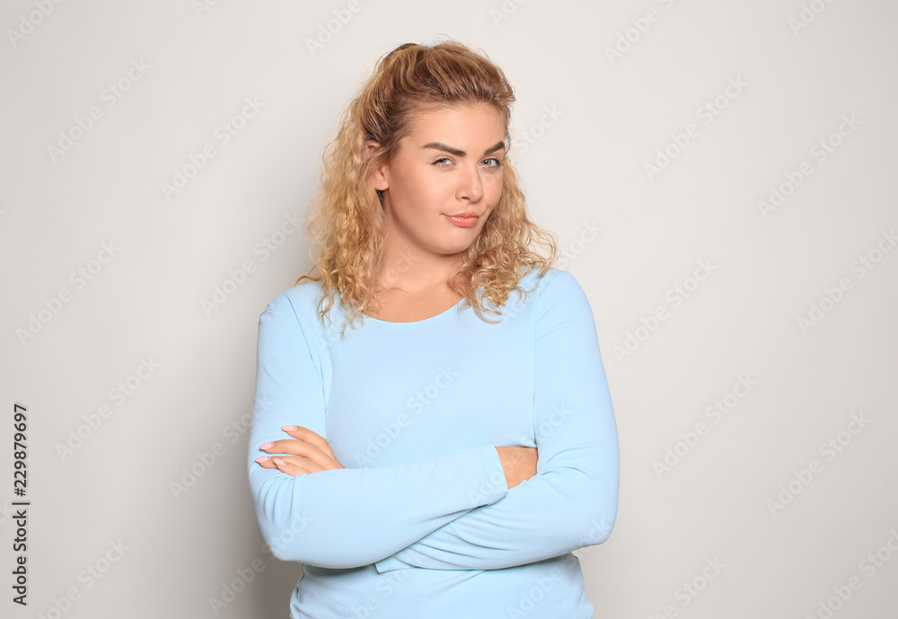 Portrait of suspicious young woman on light background Portrait of suspicious young woman on light background