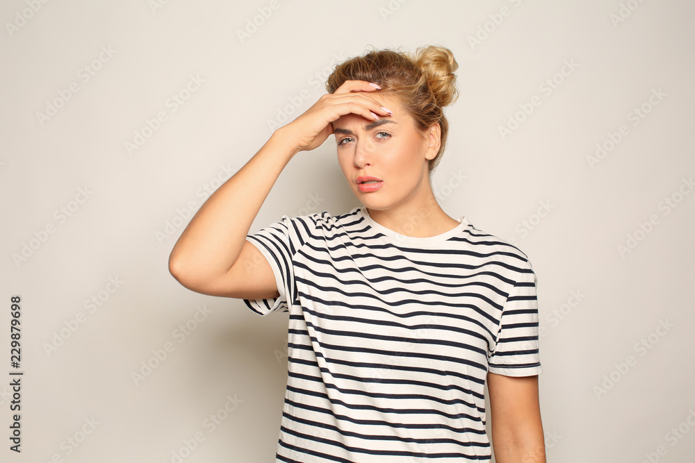 Portrait of beautiful tired young woman on light background Portrait of beautiful tired young woman on light background