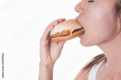 close up face portrait of asia woman eating fast food cheese burger