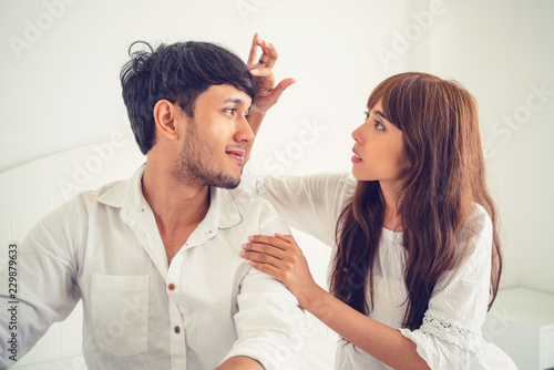 Happy young couple relaxing in the home bedroom. photo