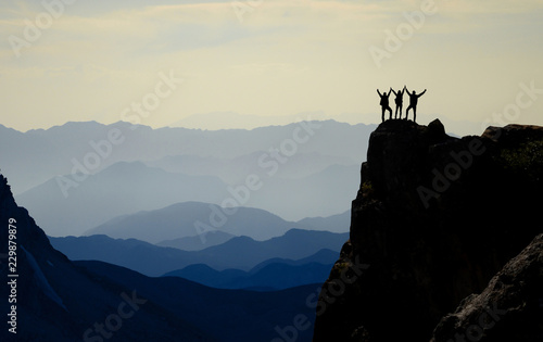 successful climbers, mountain range and spectacular depth photo