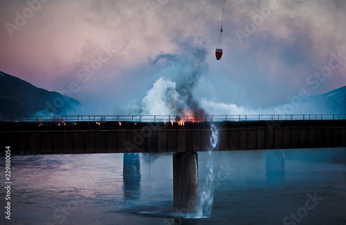 fire fighter helicopter bucket onto bridge fire © jordan