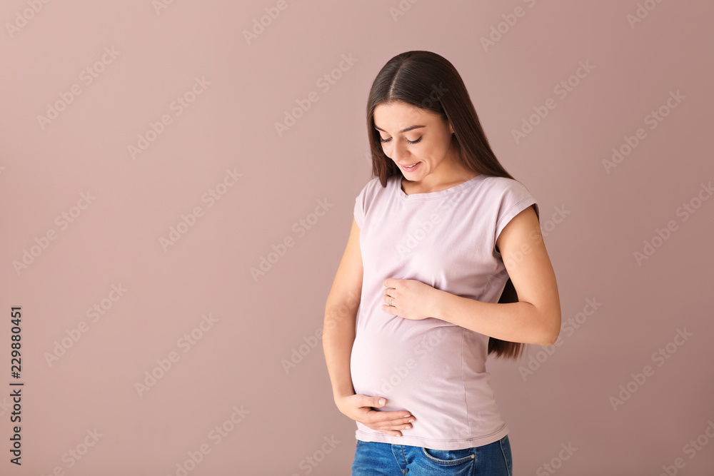 Beautiful pregnant woman on color background Beautiful pregnant woman on color background