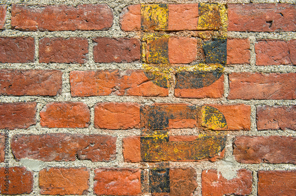 Fototapeta premium brick wall background with fading yellow letters
