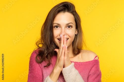 emotion face. overwhelmed perplexed shocked surprised astounded woman. young beautiful brown haired girl portrait on yellow background.