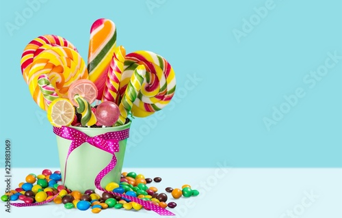 Colorful candies in bucket isolated on white