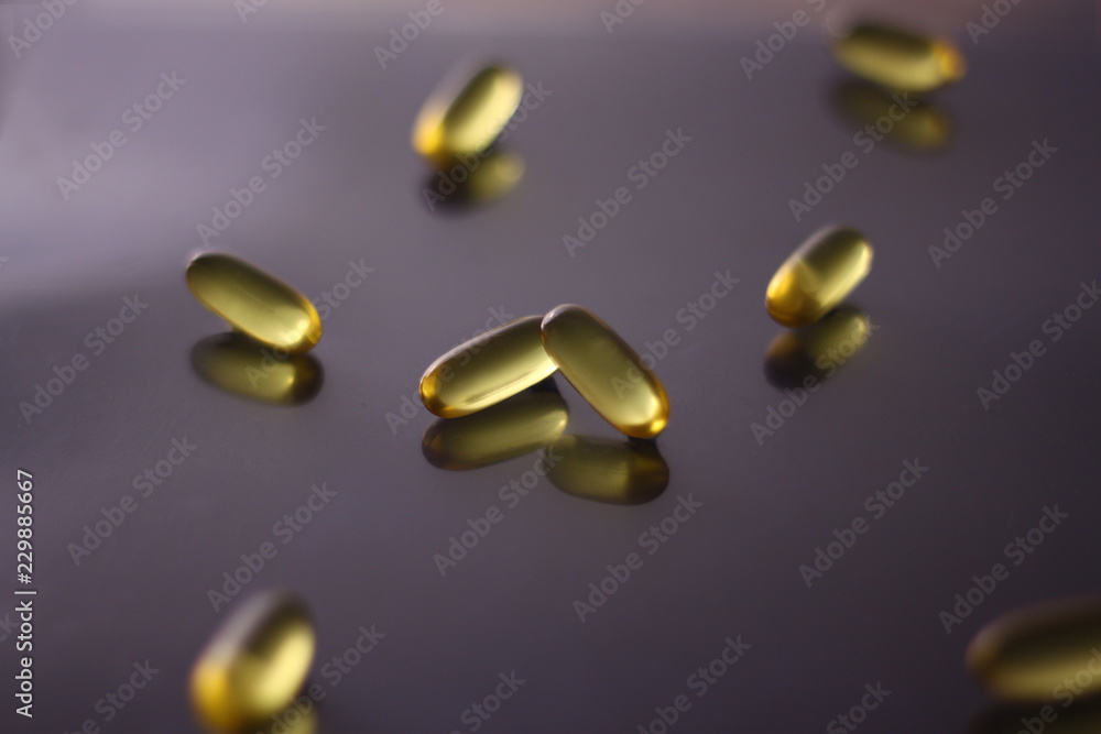 fish oil capsules on black background fish oil capsules on black background