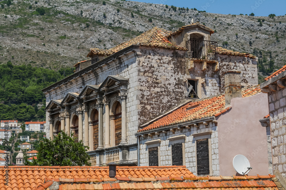 Obraz premium old stone building with a tiled roof and boarded up windows in Dubrovnik. Croatia