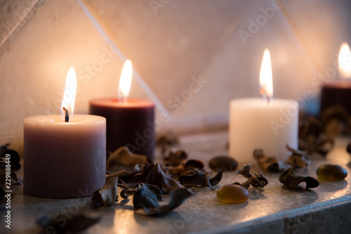 relaxing spa background with candles and some wooden petals