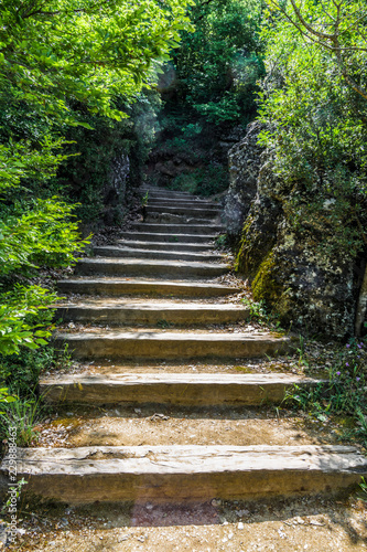 A wooden staircase leads to the mountain monastery