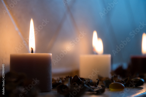 relaxing spa background with candles and some wooden petals