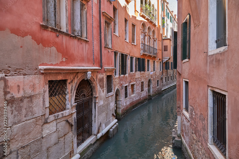 Venice narrow canal, ancient buildings and houses facades in Italy, nobody