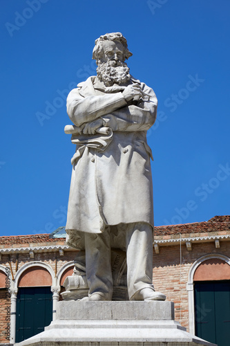 Niccolo Tommaseo statue in Venice by Francesco Barzaghi  1839-1892  in a sunny summer day in Italy