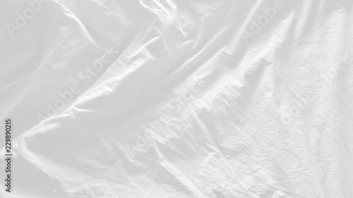 close up top view of white pillow on bed and with wrinkle messy blanket in bedroom, from sleeping in a long night. abstract texture for white background 