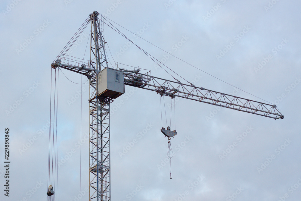 Gray industry crane at cloudy sky background texture. low contrast Gray industry crane at cloudy sky background texture. low contrast